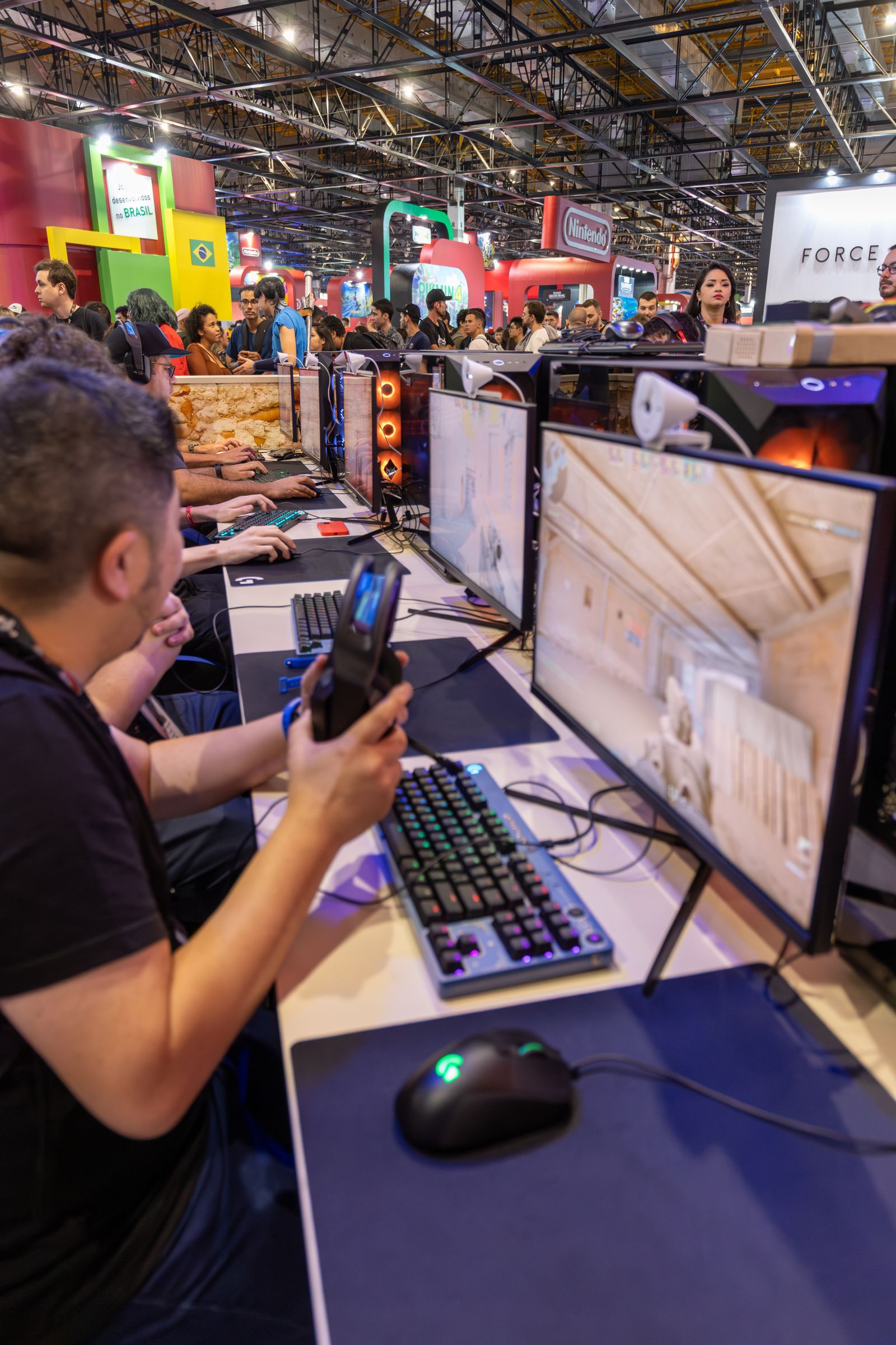 Players competing on computers at a gaming convention