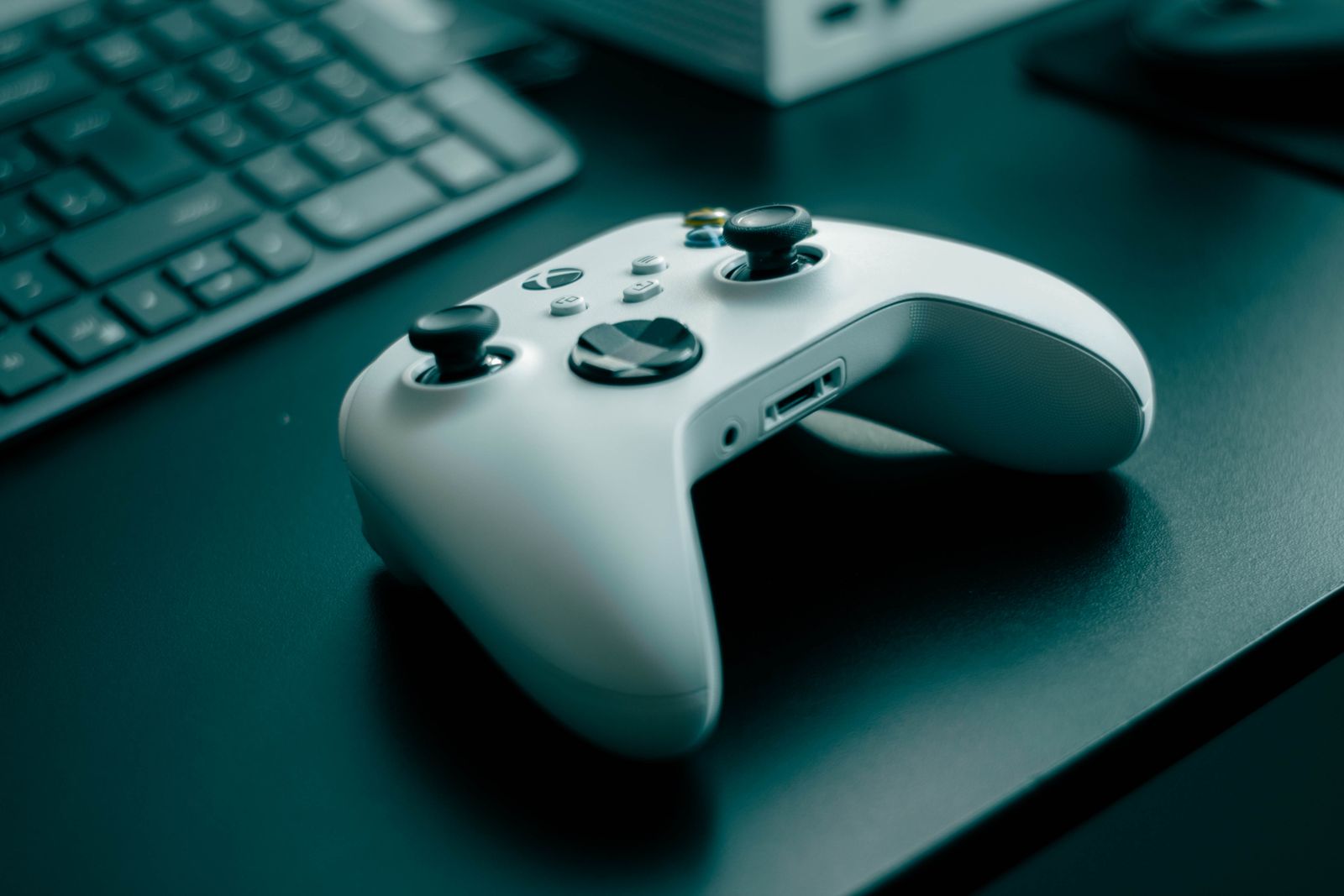 White Xbox-style game controller on a clean desk gaming setup